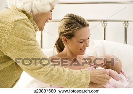 A grandmother greeting her new grandchild after the birth View Large Photo Image Stock Image - A grandmother greeting her new grandchild after the birth. Fotosearch