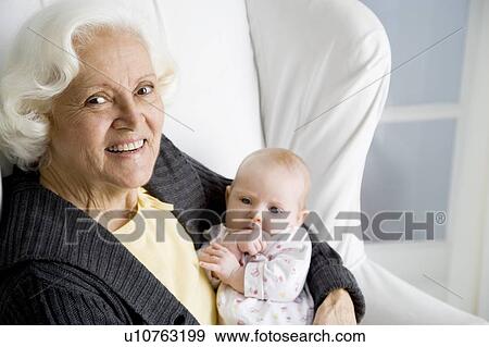 Stock Photo - A grandmother holding her new grandchild. Fotosearch