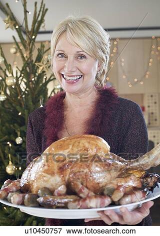 A grandmother with the Christmas turkey View Large Photo Image Stock Photo - A grandmother with the Christmas turkey. Fotosearch