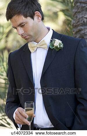 A groom drinking champagne View Large Photo Image Picture - A groom drinking champagne. Fotosearch