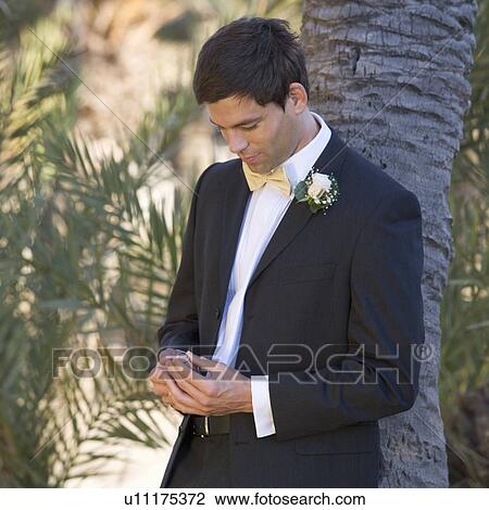 Stock Image - A groom looking at the wedding ring. Fotosearch