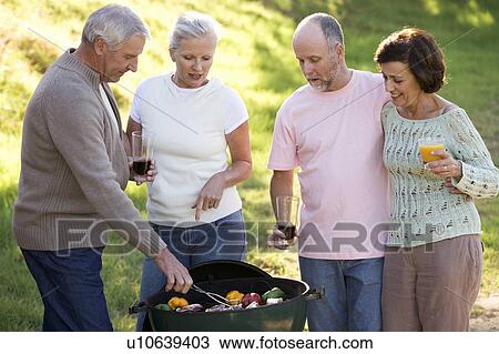 A group of senior friends having a barbeque View Large Photo Image Stock Image - A group of senior friends having a barbeque. Fotosearch