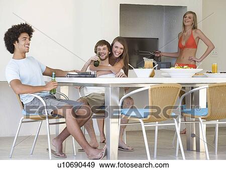 Stock Photo - A group of teenage friends at a barbeque. Fotosearch
