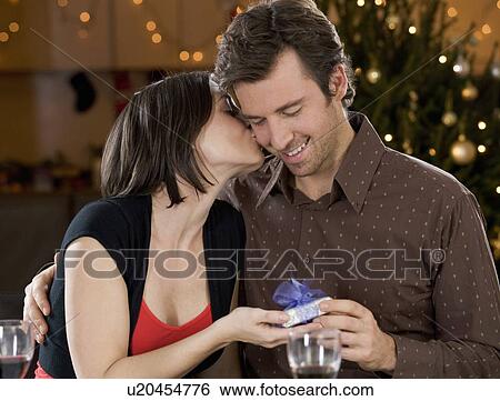 Stock Photograph - A husband and wife exchanging gifts. Fotosearch