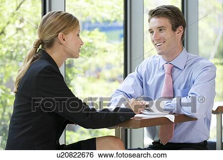 Stock Photograph - A man and women discussing business. Fotosearch