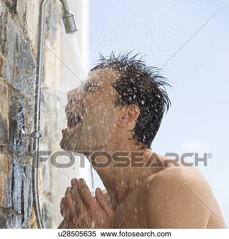 Stock Photography - A man cooling off under a shower. Fotosearch