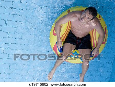 Stock Image - A man having fun in a waterpark. Fotosearch