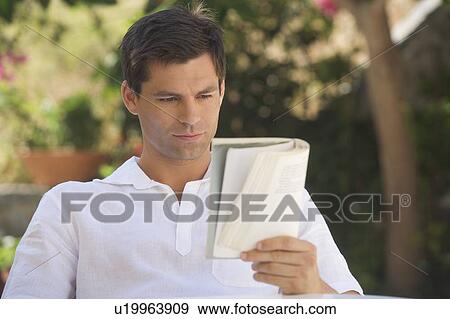 A man reading a book View Large Photo Image Stock Photo - A man reading a book. Fotosearch