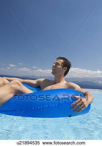 A man relaxing in a pool View Large Photo Image Stock Photography - A man relaxing in a pool. Fotosearch