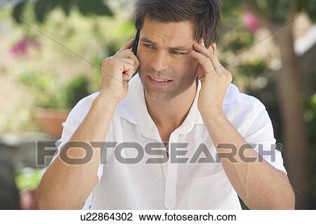 A man talking on a mobile phone View Large Photo Image Stock Image - A man talking on a mobile phone. Fotosearch
