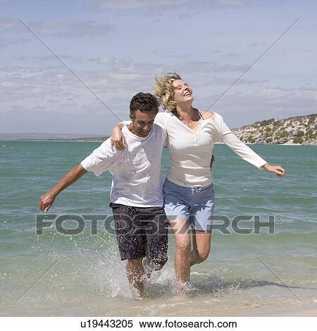 A mature couple on a beach View Large Photo Image Stock Photography - A mature couple on a beach. Fotosearch