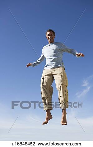 A mature man jumping View Large Photo Image Stock Image - A mature man jumping. Fotosearch