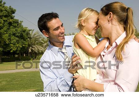 Stock Photo - A mother and father with their young daughter. Fotosearch