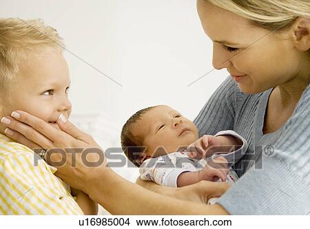 A mother and her son with a new baby View Large Photo Image Picture - A mother and her son with a new baby. Fotosearch
