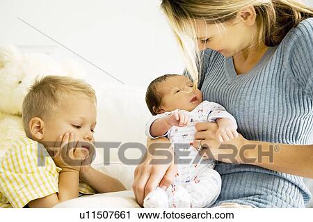 Stock Image - A mother and her son with a new baby. Fotosearch