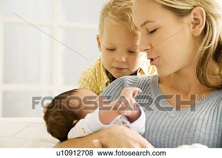 Stock Photo - A mother and her son with a new baby. Fotosearch