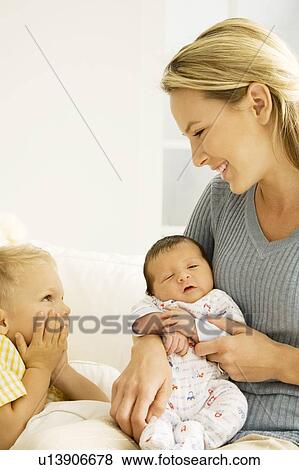 A mother and her son with a new baby View Large Photo Image Stock Photo - A mother and her son with a new baby. Fotosearch