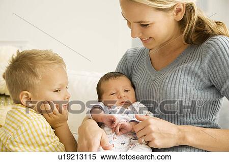 A mother and her son with a new baby View Large Photo Image Stock Photography - A mother and her son with a new baby. Fotosearch