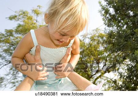 A mother lifting her young daughter View Large Photo Image Stock Image - A mother lifting her young daughter. Fotosearch
