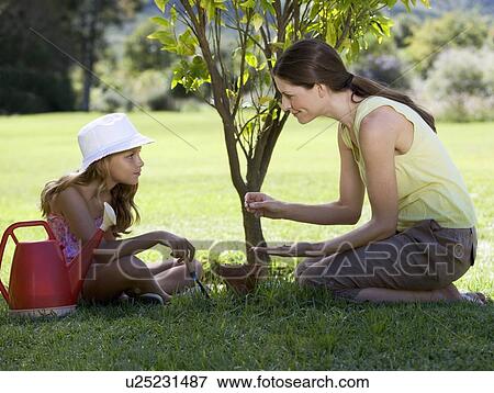 A mother with her young daughter gardening View Large Photo Image Stock Photo - A mother with her young daughter gardening. Fotosearch