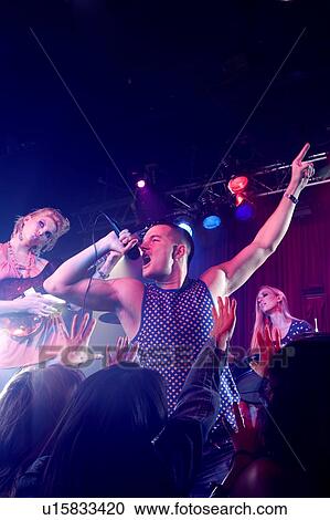 A pop group performing View Large Photo Image Stock Image - A pop group performing. Fotosearch