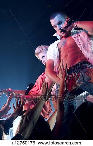 A pop group performing View Large Photo Image Stock Photograph - A pop group performing. Fotosearch