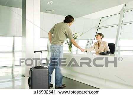 Stock Image - A receptionist greeting a visitor. Fotosearch
