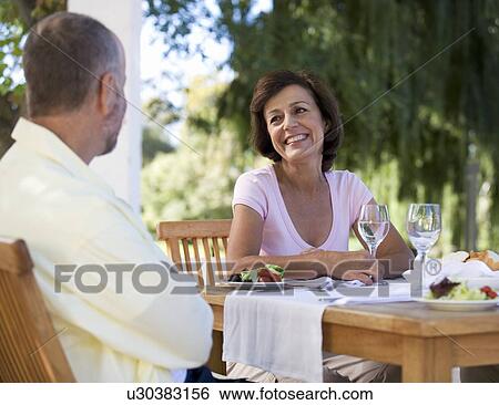 Stock Photograph - A senior couple at a restaurant. Fotosearch