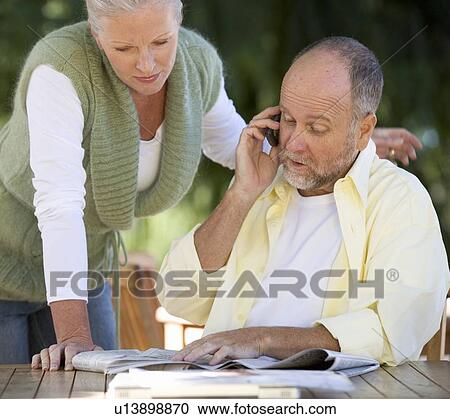 A senior couple discussing an article in a paper View Large Photo Image Stock Image - A senior couple discussing an article in a paper. Fotosearch