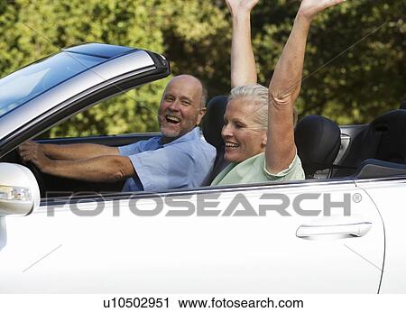 A senior couple driving a car View Large Photo Image Stock Image - A senior couple driving a car. Fotosearch