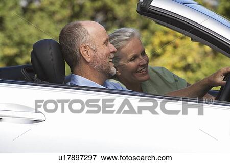Stock Photo - A senior couple driving a car. Fotosearch