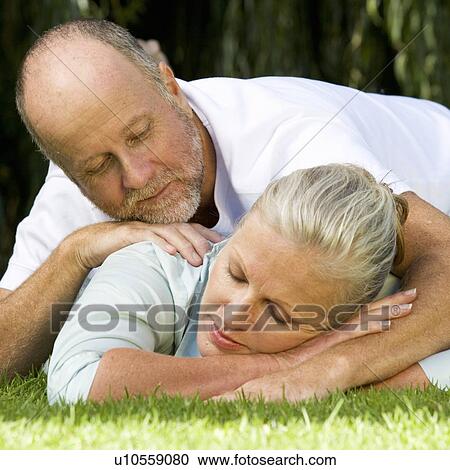 Stock Image - A senior couple in a garden. Fotosearch