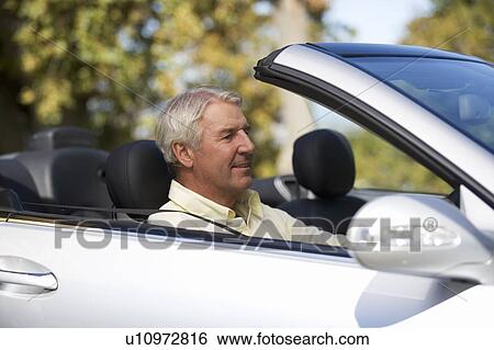 A senior man driving a car View Large Photo Image Stock Photograph - A senior man driving a car. Fotosearch