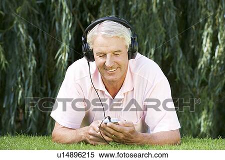 A senior man listening to music View Large Photo Image Stock Photography - A senior man listening to music. Fotosearch