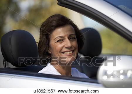 A senior woman driving a car View Large Photo Image Stock Photo - A senior woman driving a car. Fotosearch