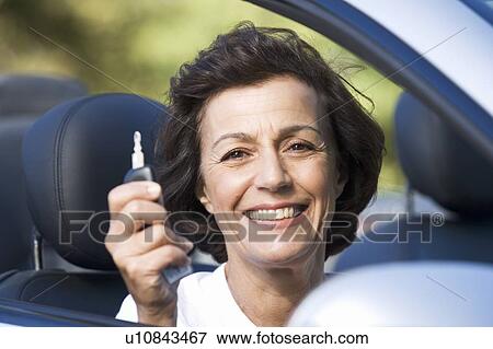Stock Photo - A senior woman in her car. Fotosearch