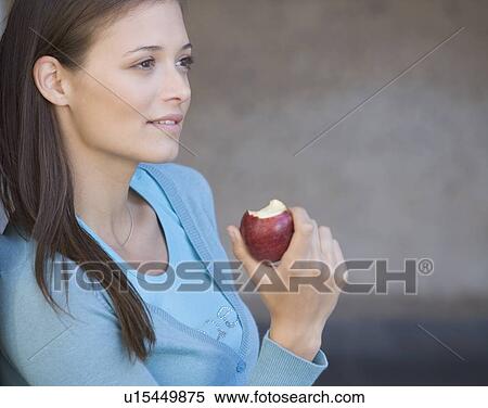 Stock Photography - A student eating an apple. Fotosearch