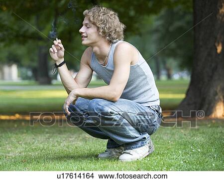 A teenage boy smoking View Large Photo Image Picture - A teenage boy smoking. Fotosearch