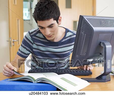 Stock Image - A teenage boy studying. Fotosearch