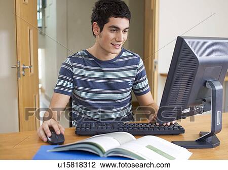 A teenage boy using a computer View Large Photo Image Stock Image - A teenage boy using a computer. Fotosearch