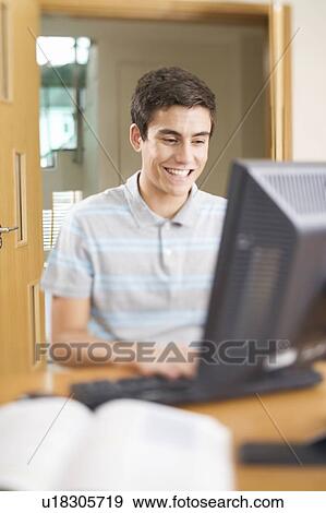 A teenage boy using a computer View Large Photo Image Stock Photo - A teenage boy using a computer. Fotosearch