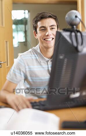 A teenage boy using a computer View Large Photo Image Stock Photography - A teenage boy using a computer. Fotosearch
