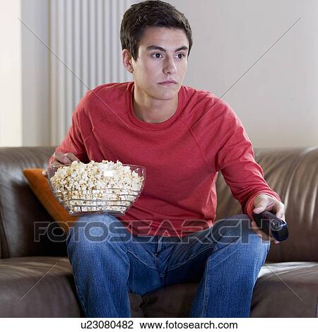Stock Image - A teenage boy watching television. Fotosearch