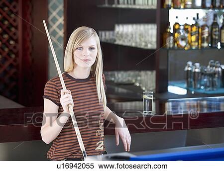 Stock Photography - A teenage girl playing pool. Fotosearch