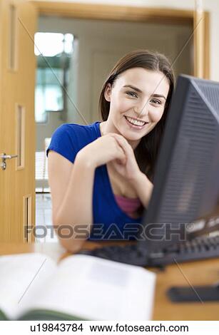 Picture - A teenage girl using a computer. Fotosearch