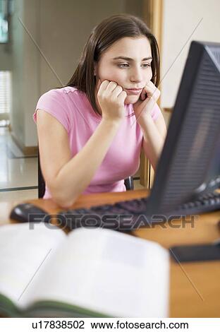 A teenage girl using a computer View Large Photo Image Stock Image - A teenage girl using a computer. Fotosearch