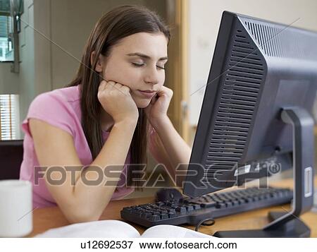 A teenage girl using a computer View Large Photo Image Stock Photo - A teenage girl using a computer. Fotosearch