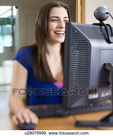Stock Photo - A teenage girl using a computer. Fotosearch