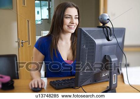 A teenage girl using a computer View Large Photo Image Stock Photography - A teenage girl using a computer. Fotosearch