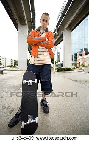 A teenager with a skateboard View Large Photo Image Stock Photo - A teenager with a skateboard. Fotosearch